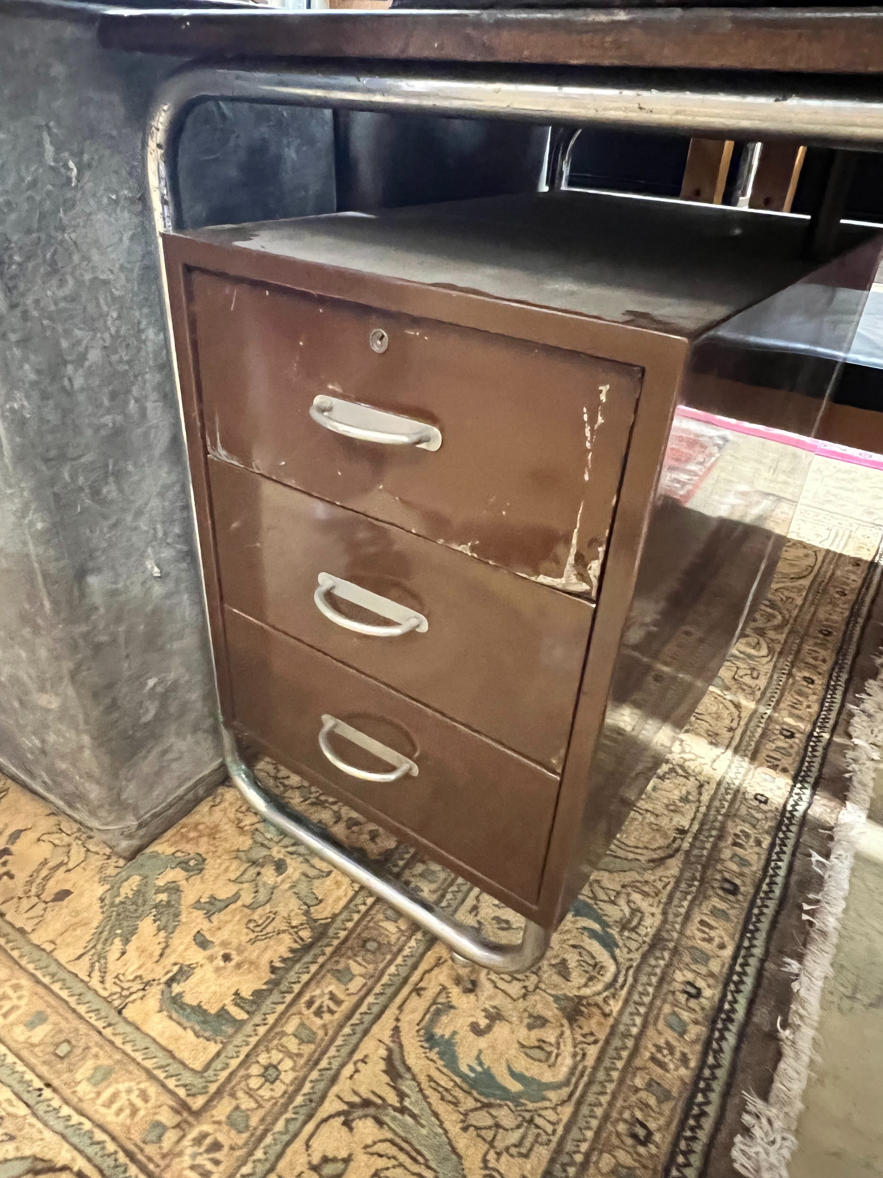 A modernist metal and beech kneehole desk, width 120cm depth 70cm height 75cm